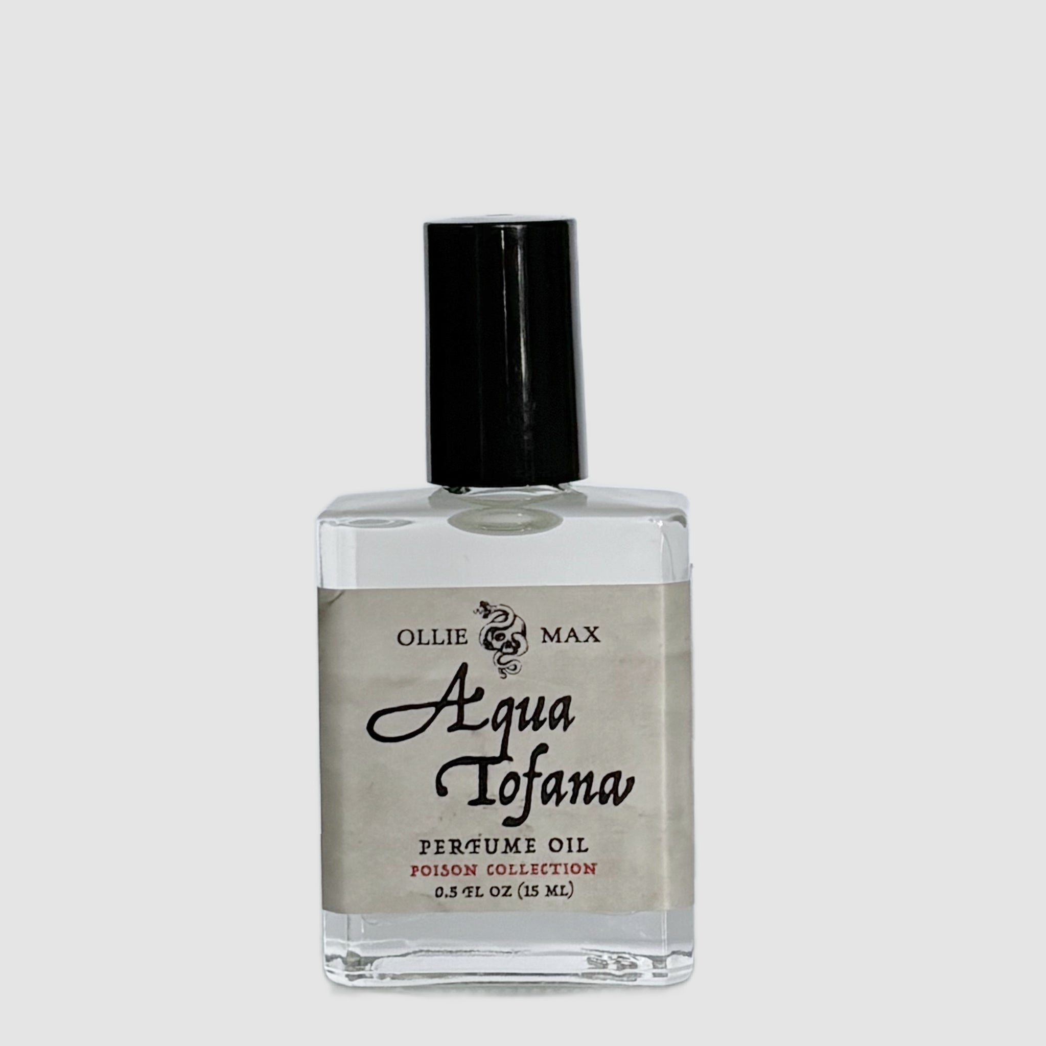rectangle glass bottle with a tall black cap.  Perfume is named aqua Tofana a the label is light tan with a parchment paper appearance. 15ml vegan perfume